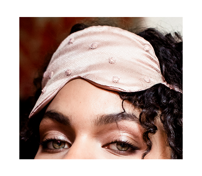 Eye mask detail with fine lace overlay on luxury pink silk