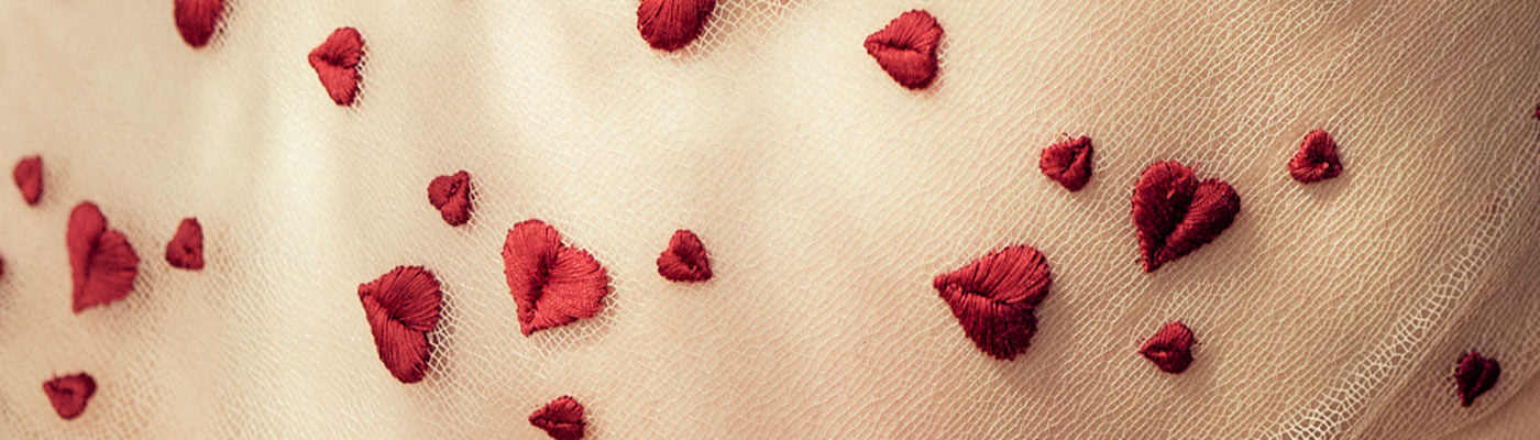 Fancy French red heart embroidered lace on an invisible ground.