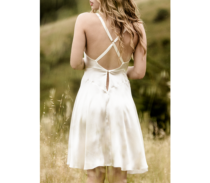Crossover back straps on ivory silk slip dress with vintage inspired cut in luxury silk charmeuse