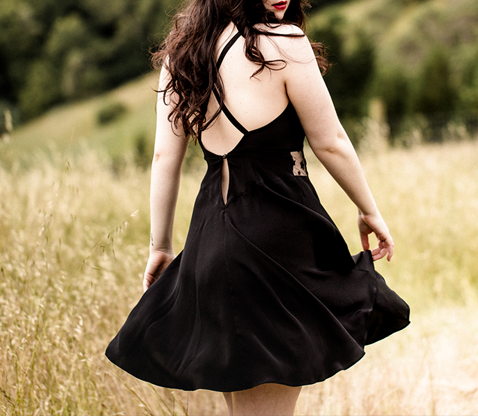 Black silk slip dress with lace detail, crossover back and short length