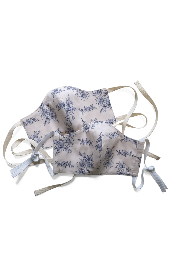 Cotton face mask covering in blue and white printed cotton with elastic or tape fastening