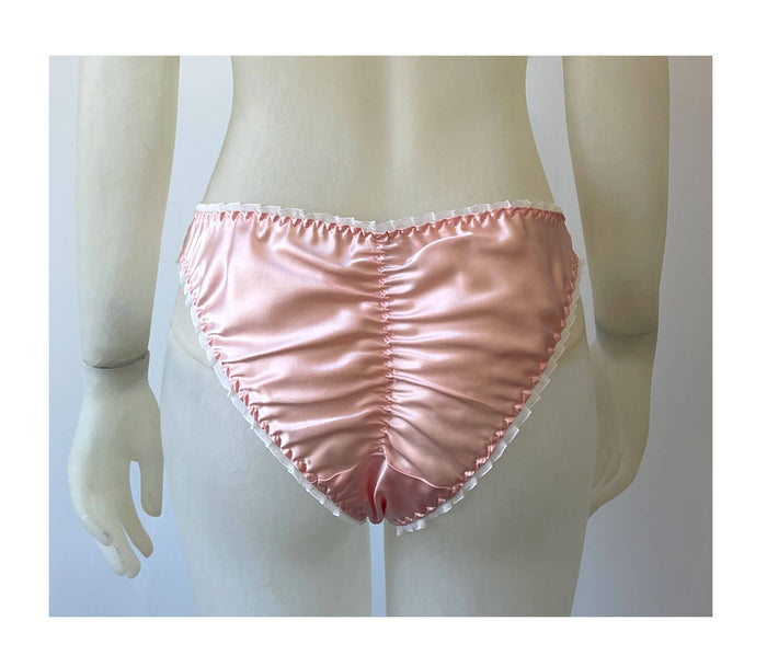 Ruched ruffled seat on pink shiny silk panty with high cut legs and white ruffle elastic for burlesque retro 1990s style